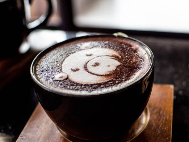 istock Cup of coffee latte and bear face bubble aet on wood table 1142859099