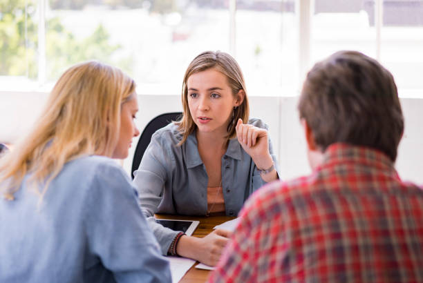 istock Female counselor explaining couple in office 1142859908