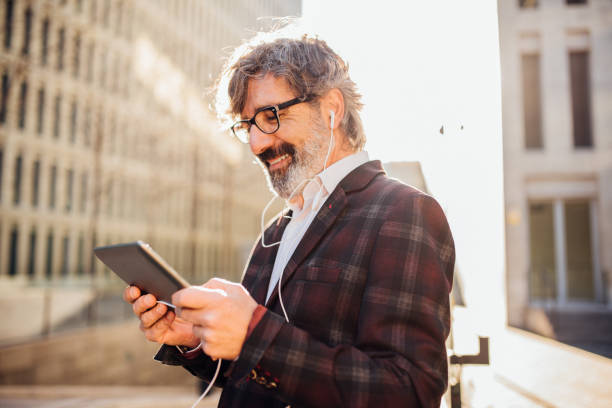 istock Man listening podcast via digital tablet 1142859959