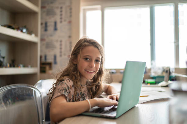 istock Portrait of elementary age girl doing homework 1142860734
