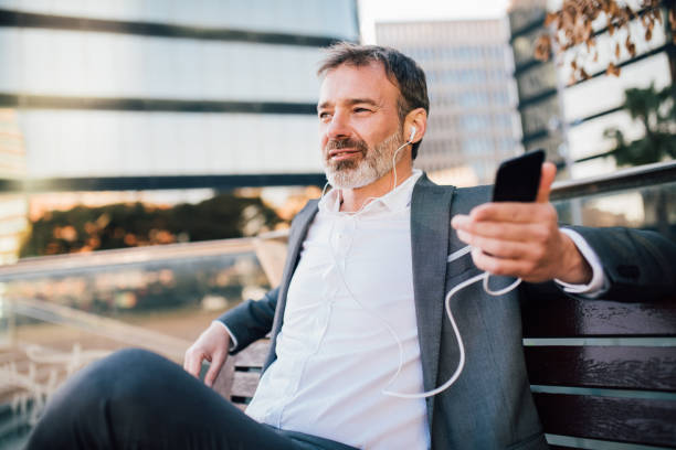 istock Old man listening podcast via mobile phone 1142860850
