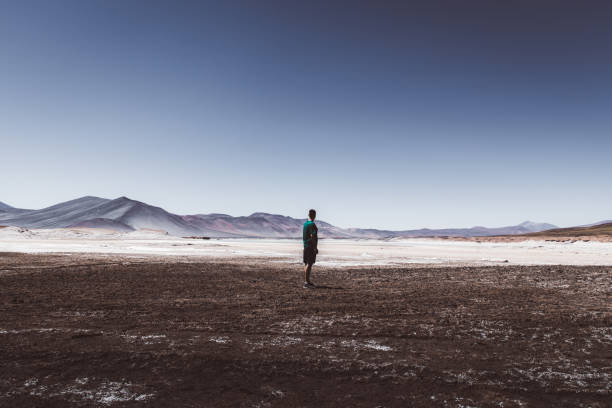 istock Man walking at salt flat in Atacama desert 1142862072