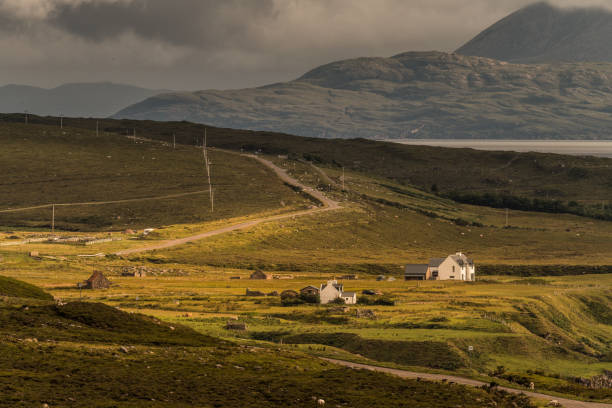 Typical landscape on the Gaelic peninsula Applecross Typical landscape with houses and pastures on the Gaelic peninsula Applecross, Strathcarron, Inner Hebrides, Scotland, UK applecross peninsula stock pictures, royalty-free photos & images