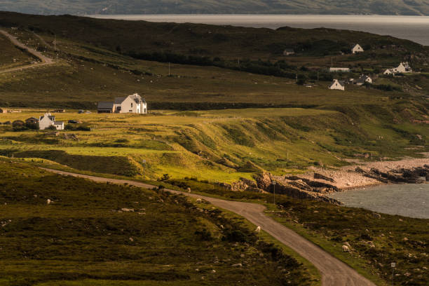 Typical landscape on the Gaelic peninsula Applecross Typical landscape with coast, houses and pastures on the Gaelic peninsula Applecross, Strathcarron, Inner Hebrides, Scotland, UK applecross peninsula stock pictures, royalty-free photos & images