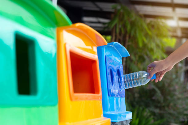 istock Woman hand throwing empty plastic bottle into the trash, Recycling Concept. 1142867036