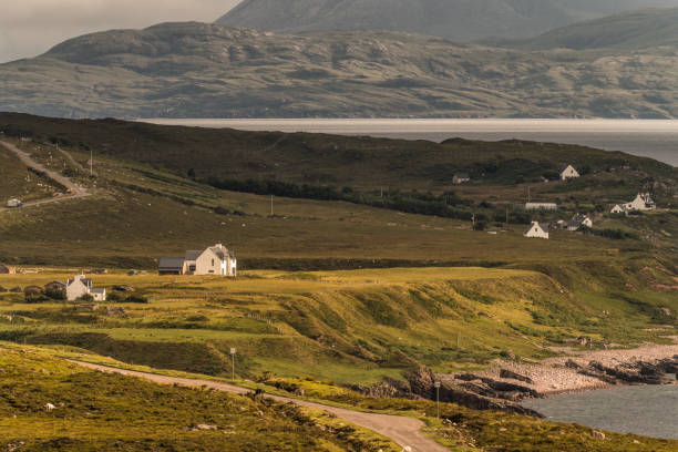 Typical landscape on the Gaelic peninsula Applecross Typical landscape with houses and pastures on the Gaelic peninsula Applecross, Strathcarron, Inner Hebrides, Scotland, UK applecross peninsula stock pictures, royalty-free photos & images