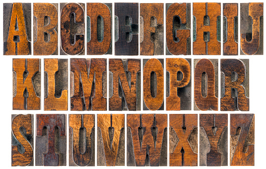 alphabet in vintage letterpress wood type blocks, French Clarendon font popular in western movies and memorabilia, a collage of 26 isolated letters