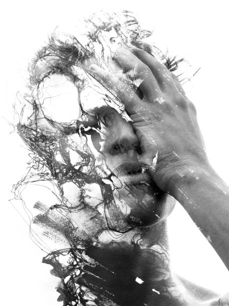 Paintography. Double exposure of an attractive male model combined with hand drawn ink paintings with depth and texture, black and white stock photo