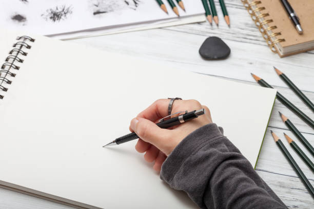 istock Woman artist hand drawing on sketchbook 1142871069