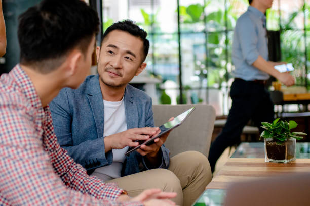 istock Coworkers having an informal meeting in a modern office 1142871122