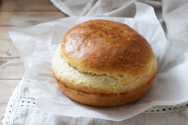istock Fresh homemade wheat yeast bread on a linen tablecloth. Rustic style. 1142874272