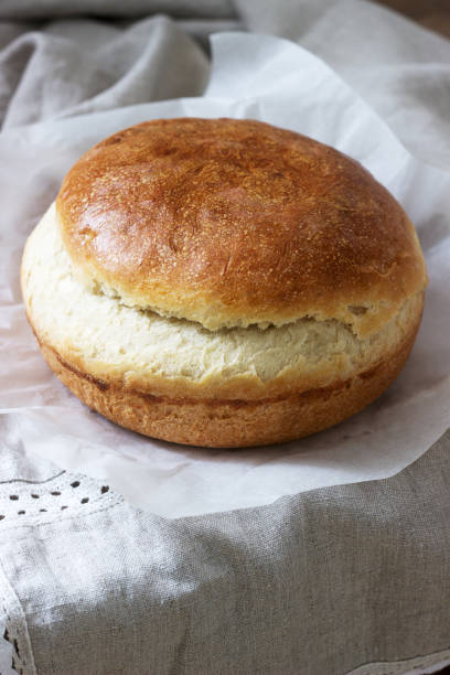 istock Fresh homemade wheat yeast bread on a linen tablecloth. Rustic style. 1142874273