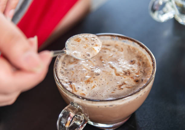 istock Hand women with cappuccino coffee in spoon 1142875561