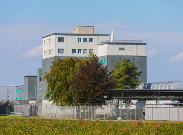 Kloten, Switzerland - September 30, 2016: the Zurich Airport Prison, a person passing along. The Zurich Airport Prison (German: Flughafengefangnis) is an extradition and remand prison, located in the territory of the Zurich Airport.