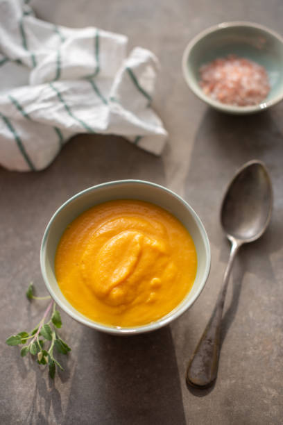 istock Vegetarian Velvety Pureed Carrot Soup with fresh sage 1142877657