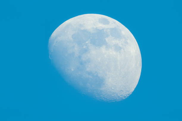 istock Moon Waxing Gibbous phase on the daytime blue sky 1142879624