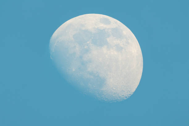 istock Moon Waxing Gibbous phase on the daytime blue sky 1142879625