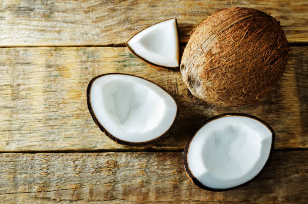 istock Coconut with slices on a wood background 1142879774