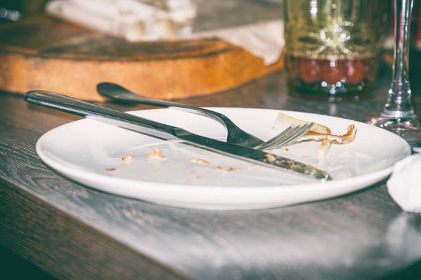 istock Knife and fork on dirty plate 1142883136