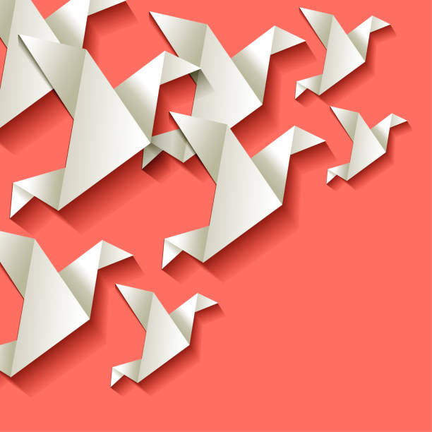 istock Origami paper birds white in the corner on a Coral color background 1142885592