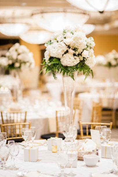 istock Wedding reception tables with stylish floral centerpiece decorations. 1142886558