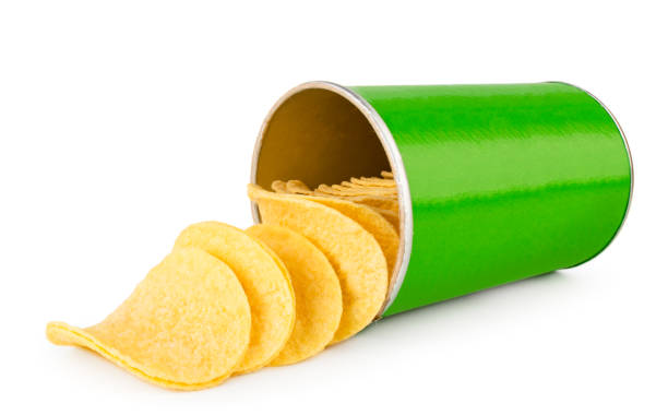 Potato chips fell out from a green jar close-up on a white background. Isolated.