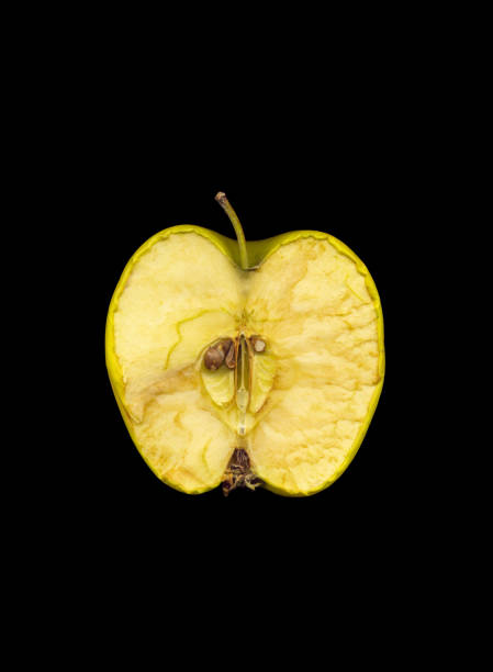 istock Green apple cut in half on black background 1142888745