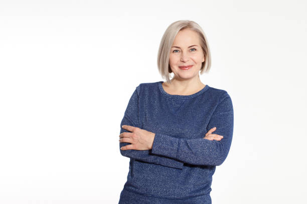 istock Attractive middle aged woman with folded arms on white background 1142889066