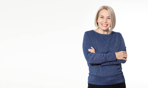 istock Attractive middle aged woman with folded arms on white background 1142889069