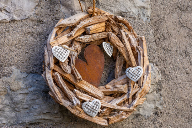 istock A wooden wrought with hearts hanging on a wall 1142890475