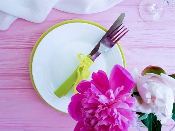 istock peony flower plate on pink wooden background 1142890666