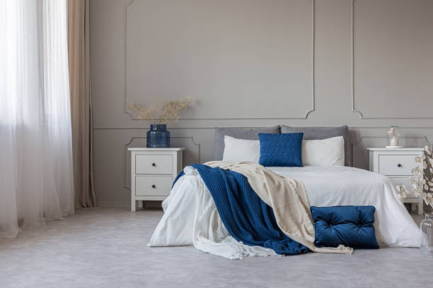 istock Copy space on empty grey wall of scandinavian bedroom interior with blue, white and grey design 1142891883