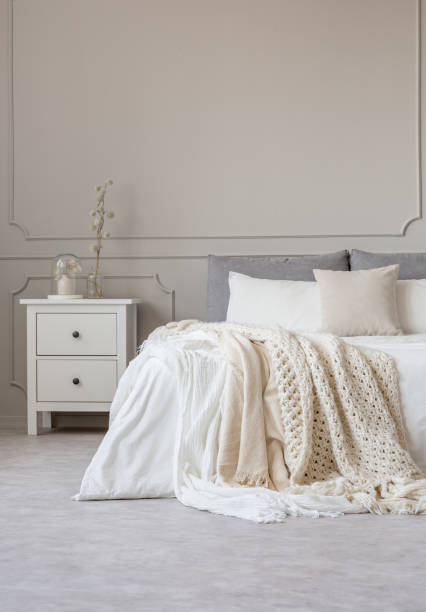 istock Copy space on empty grey wall of scandinavian bedroom interior 1142891885