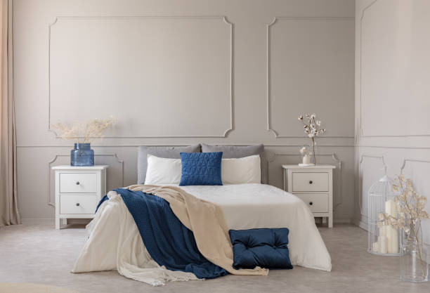 istock Copy space on empty grey wall of scandinavian bedroom interior with blue, white and grey design 1142891889