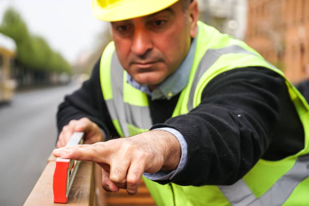 istock Construction worker measuring with a tubular spirit level 1142893475