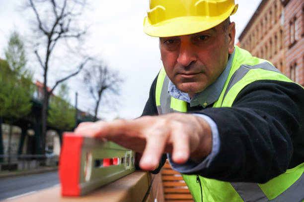 istock Construction worker measuring with a tubular spirit level 1142893511