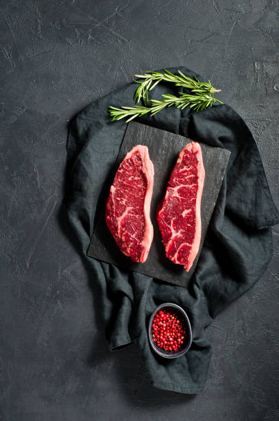 istock Steak of marbled beef black Angus. Black background, top view. 1142894154