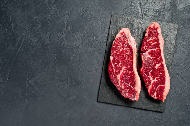 istock Raw beef ramp steak. Black background, top view. 1142895372