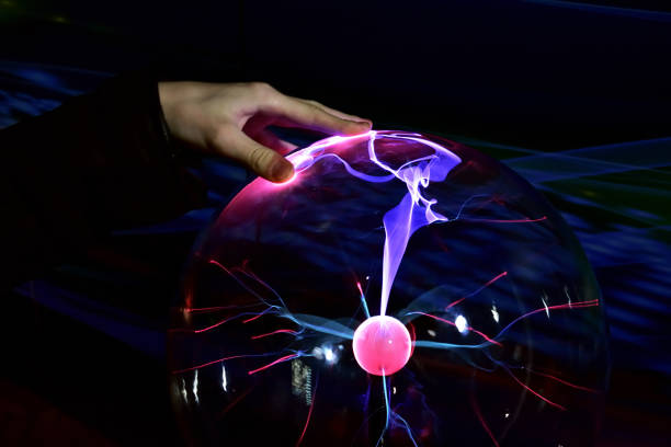 plasma protuberances streaming to the surface of a glass ball generated by tesla coil