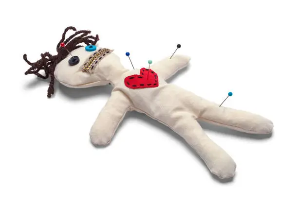 Voodoo Doll with Needles Isolated on White Background.