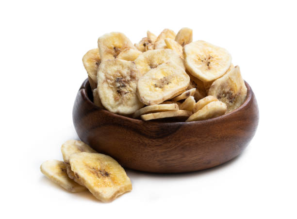 istock Homemade dehydrated banana chips isolated on white 1142899194