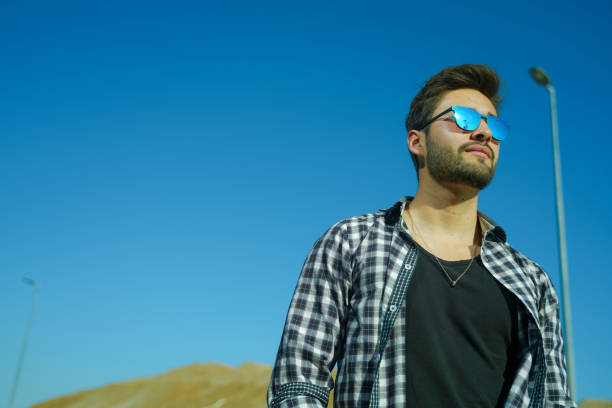 istock Young man wearing reflective sunglasses 1142899982