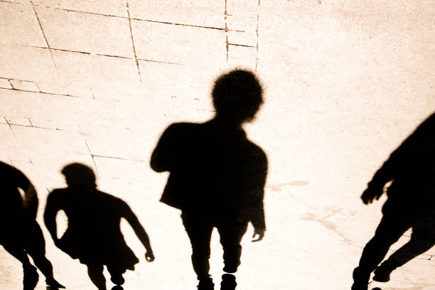 istock Blurry shadow silhouette of  people walking in high contrast 1142900380