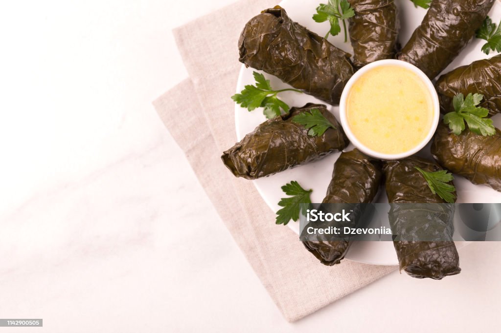 Traditional georgian cuisine. Dolma in grape leaves Traditional georgian cuisine. Dolma in grape leaves with pomegranate and parsley Armenian Culture Stock Photo