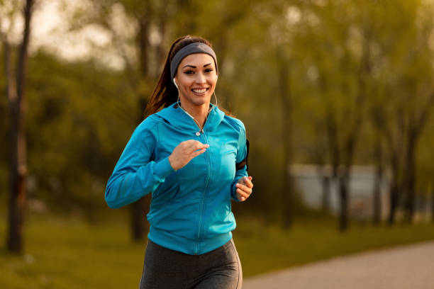 istock Happy athletic woman jogging in nature. 1142901507