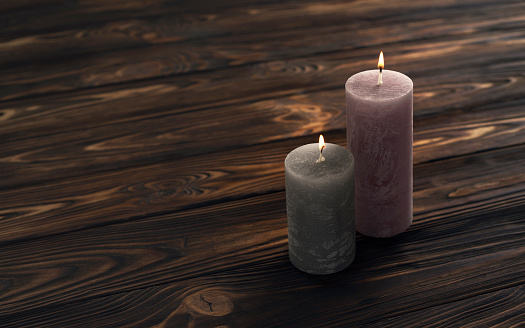 Two decoration round candles on wooden background