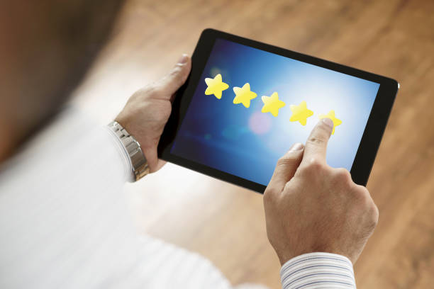 istock Man putting 5 stars excellent feedback on tablet screen 1142902092