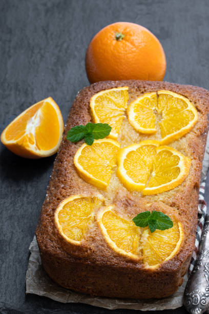istock Homemade orange syrup cake on black stone background 1142902920