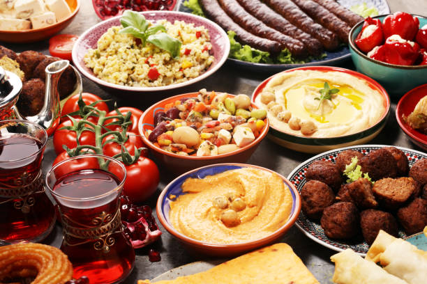 istock Middle eastern or arabic dishes and assorted meze, concrete rustic background. Falafel. Turkish Dessert Baklava with pistachio. Halal food. Lebanese cuisine 1142903242