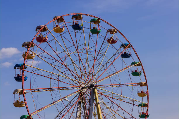 istock Ferris wheel in the park against blue sky. 1142907756